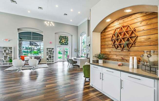 A modern kitchen with white cabinets and a wooden backsplash.