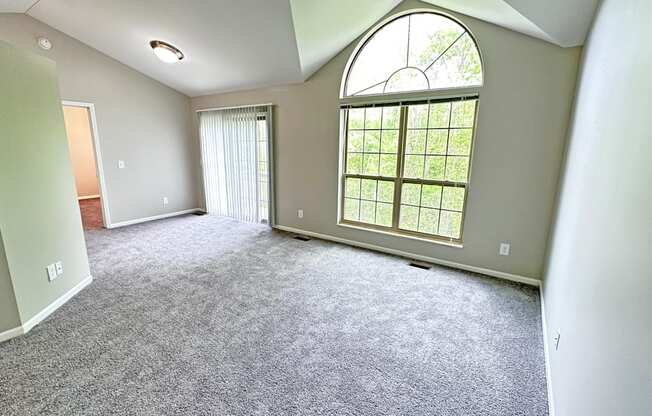 an empty living room with a large window