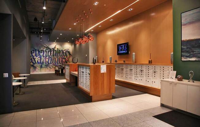 A reception area with a wooden counter and a TV mounted on the wall.