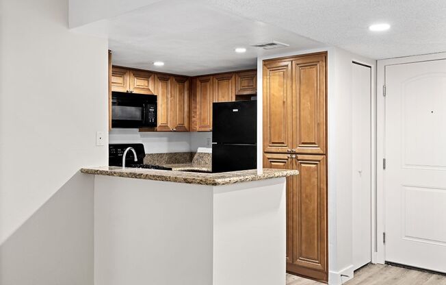 a kitchen with a counter top and a refrigerator