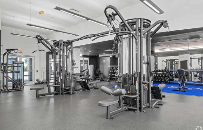 a gym with weights machines and other equipment in a hall