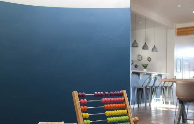 a rack of colored crayons on a wooden table