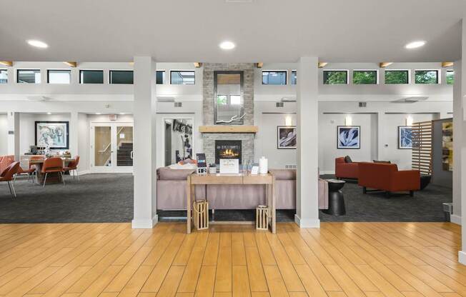 A spacious room with wooden floors and furniture.