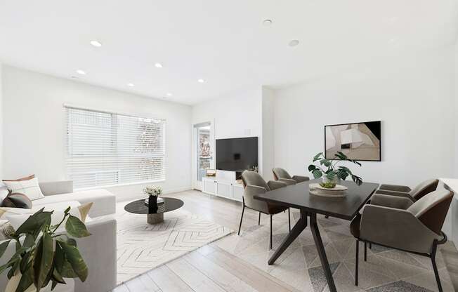 A modern living room with a black table and brown chairs.