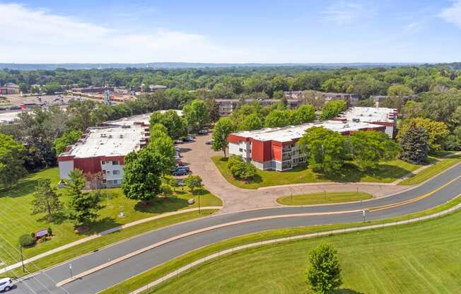 an aerial view of a campus with buildings and a road