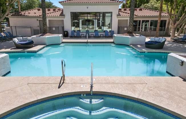 A sparkling pool with relaxing hot tub.