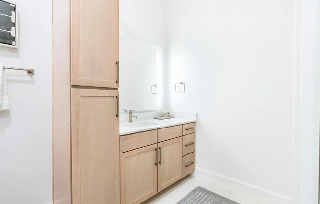 Designer bathrooms with quartz countertops and backlit mirrors*.