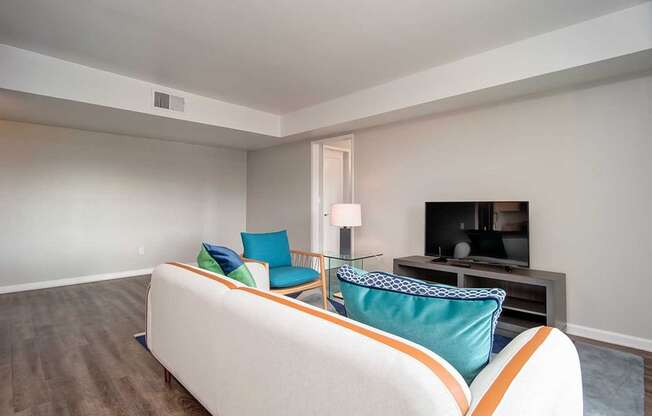 TV, White Sofa In Living Room at Los Robles Apartments, Pasadena, California