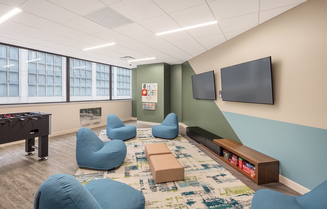 a game room with a foosball table and a television