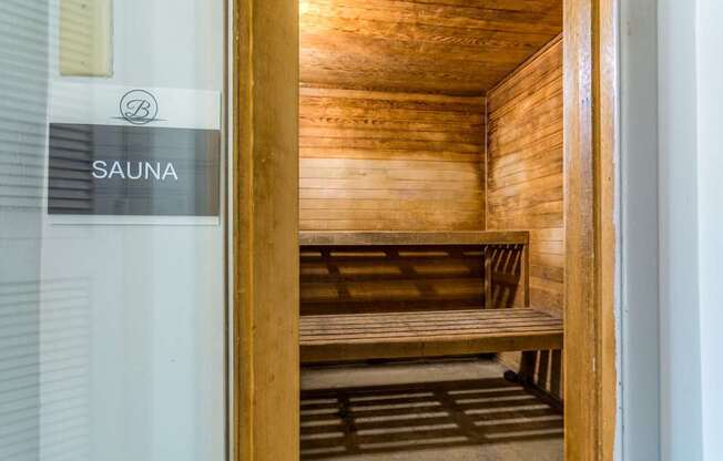 A wooden sauna with benches inside.
