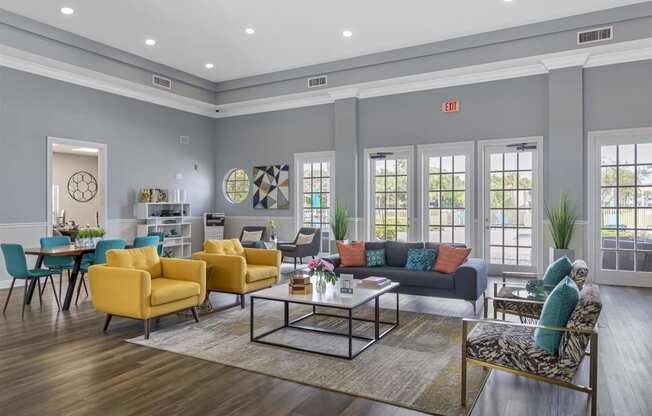 a living room with grey walls and yellow and blue furniture