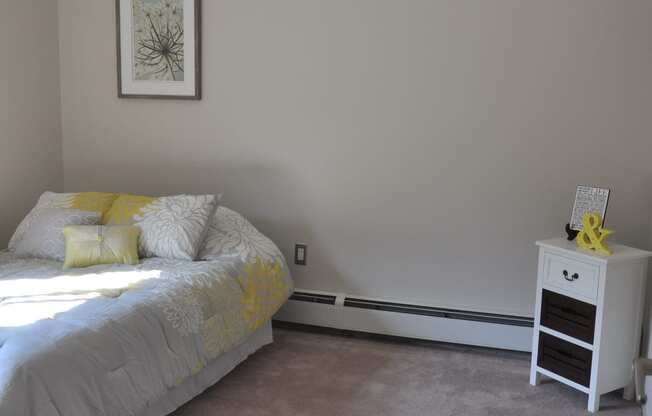 Bedroom with cozy bed and table at Summit Terrace Apartment, South Portland, ME