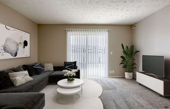 A living room with a grey couch, a white coffee table, and a painting on the wall. Omaha, NE Evergreen Terrace Apartments