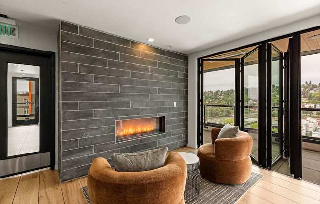 A modern living room with a fireplace and a view of the outdoors.