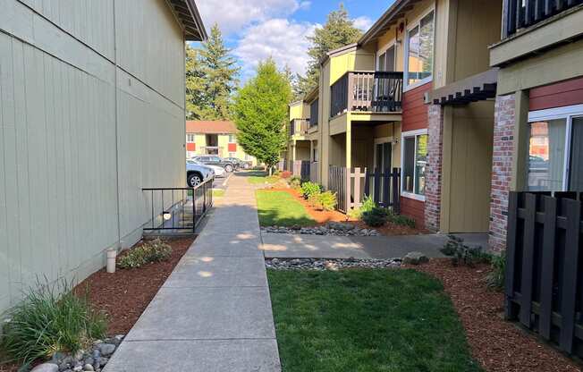 a view of a sidewalk in front of some buildings