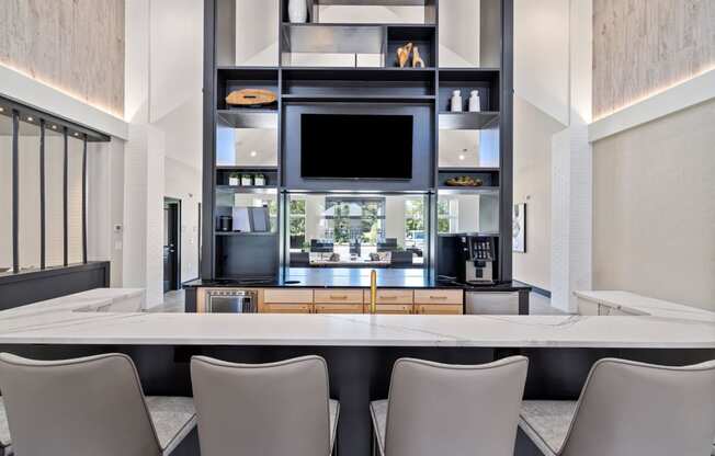 a kitchen with a table and chairs and a television