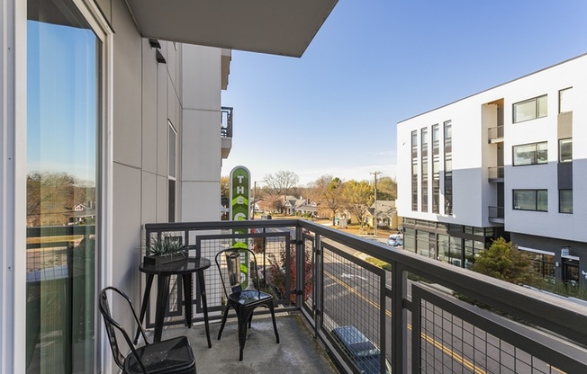 Balcony off of the unit with modern outdoor furniture
