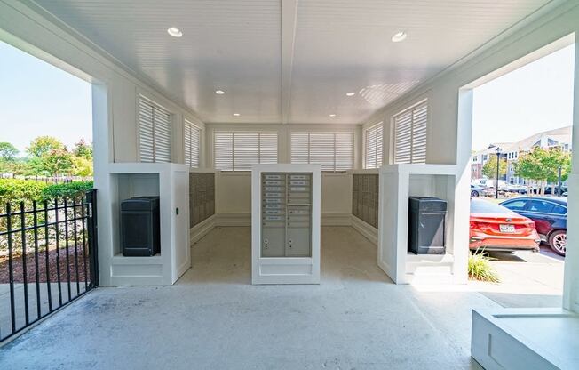 a view of the front porch of a home with mailboxes and a parking lot