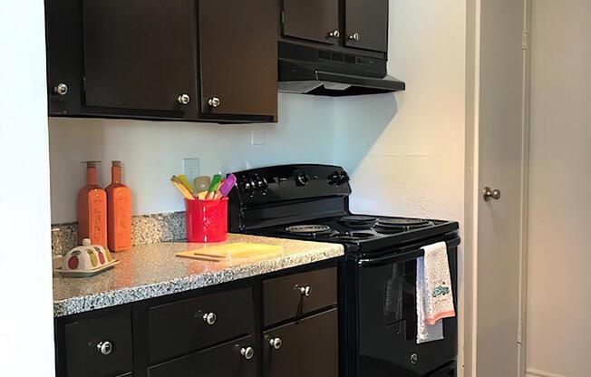 a stove top oven sitting inside of a kitchen