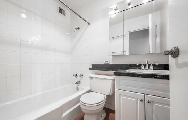 a bathroom with a sink toilet and bathtub