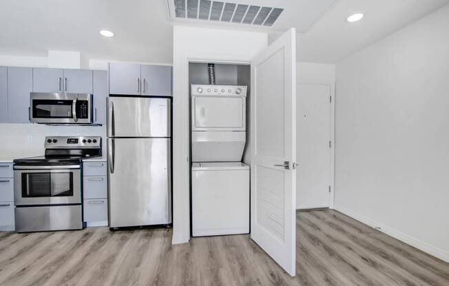 a kitchen with stainless steel appliances and white cabinets