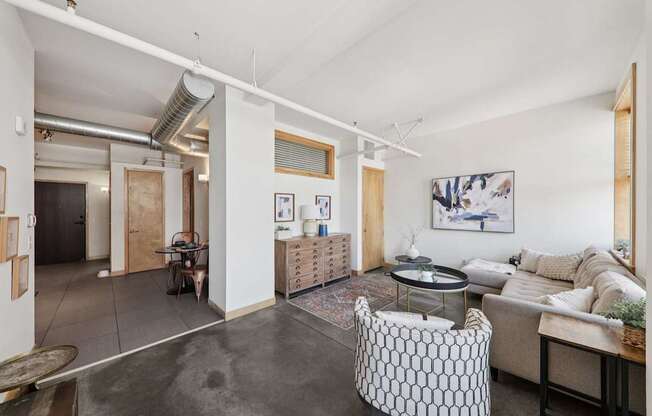 A living room with a couch, a chair, and a coffee table.