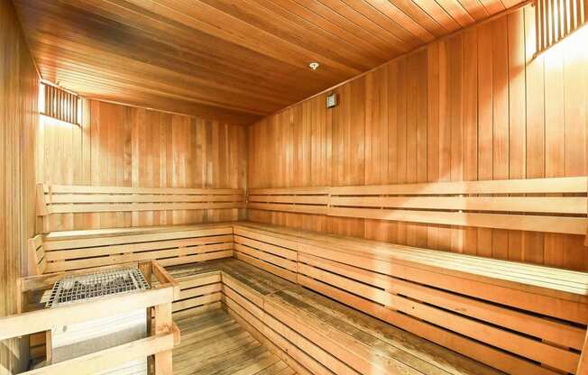 a sauna in a wooden room with wooden walls and a table