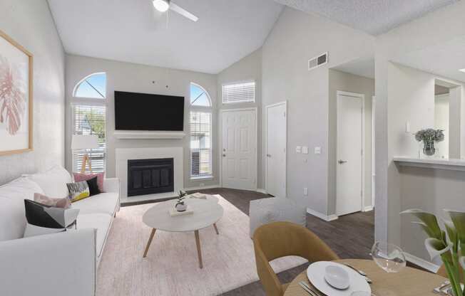 a living room with white furniture and a fireplace
