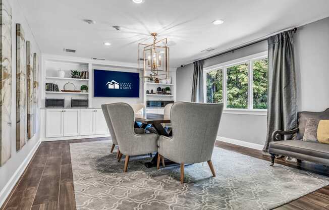 a dining room with a table and chairs and a large window