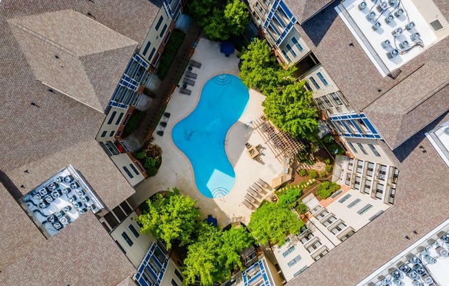 an overhead view of a pool in the middle of an apartment building