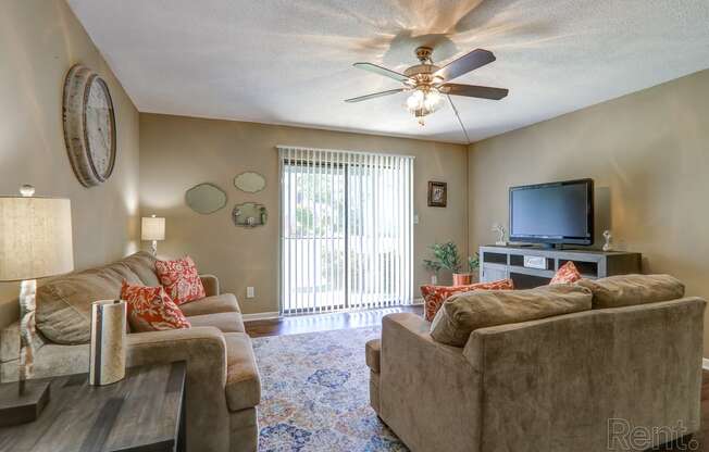 a living room with couches and a tv