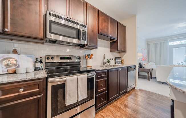 a kitchen with dark wood cabinets and stainless steel appliances