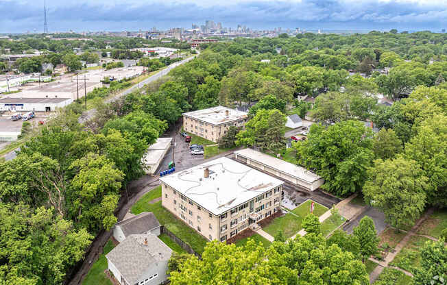 A large building surrounded by trees is the main focus of this image.