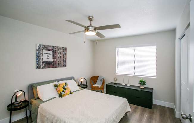 a bedroom with a bed and a ceiling fan