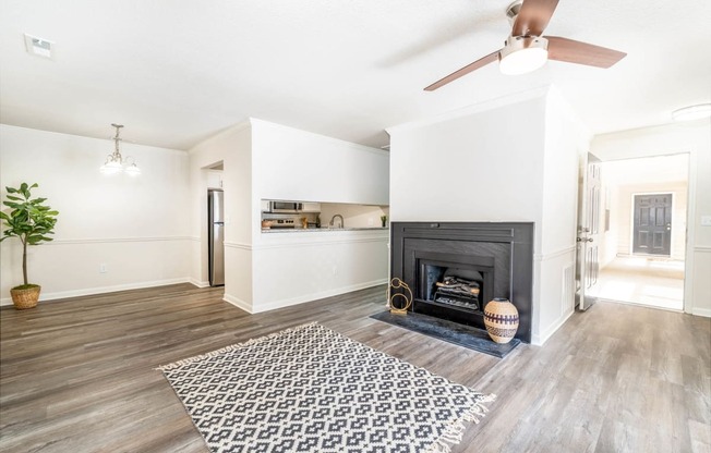 a living room with a fireplace and a rug