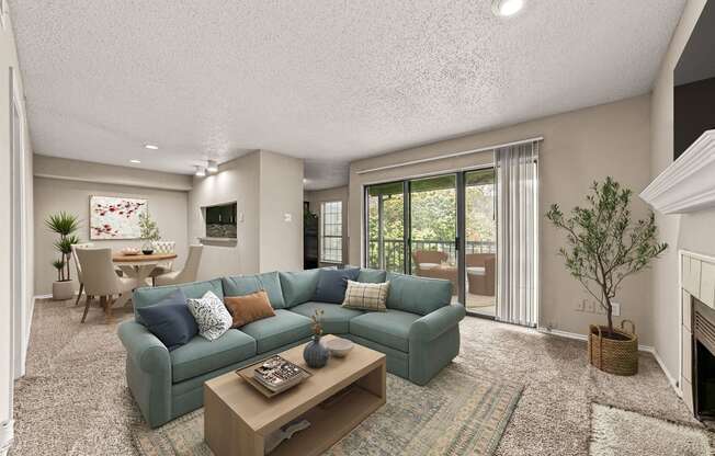 a living room with a blue couch and a coffee table at Legacy Apartments in Plano, TX