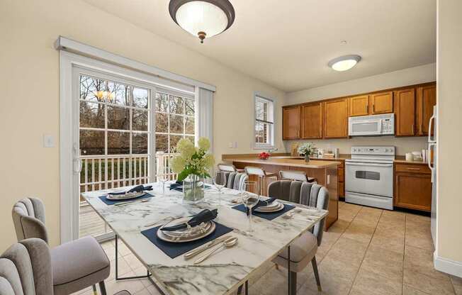 A dining room with a table set for a meal.