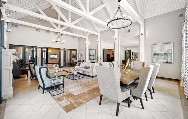 a large living room with a dining room table and chairs