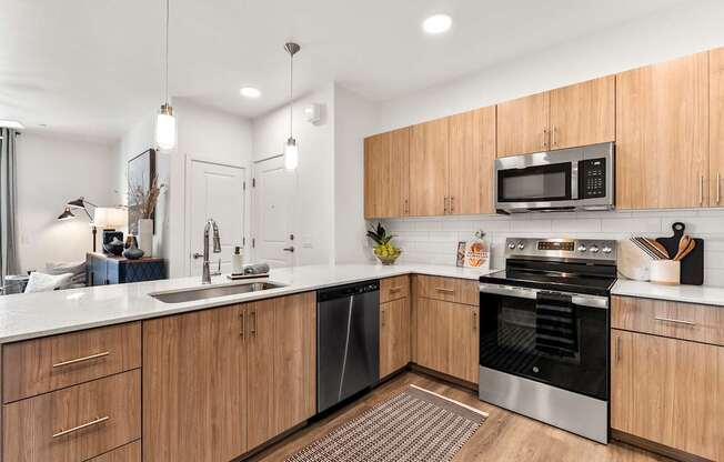 A modern kitchen with wooden cabinets and stainless steel appliances.
