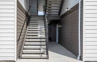 a set of stairs leading up to a building with a door