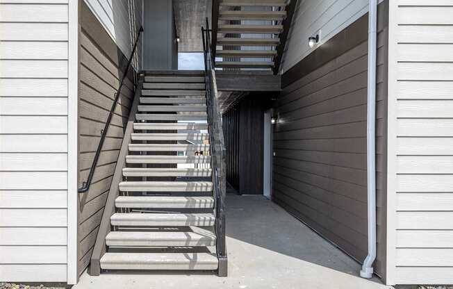 a set of stairs leading up to a building with a door