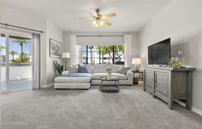 a living room with a couch and a tv at Vaseo Apartments, Phoenix Arizona
