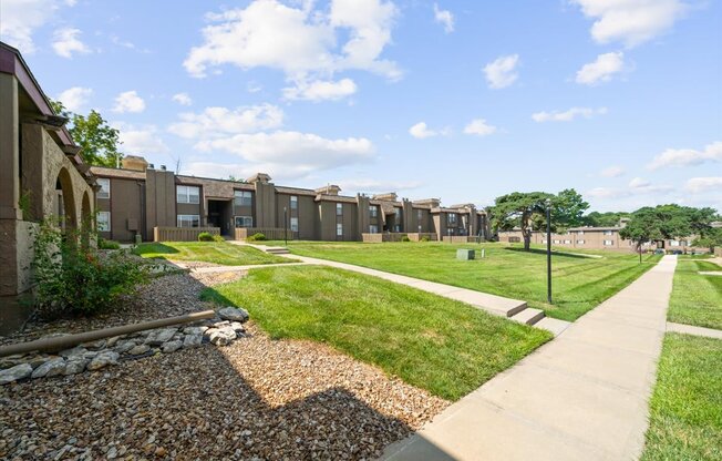 A row of houses with a gravel path in front.