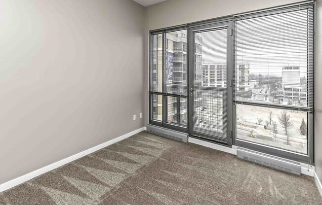 Bright Carpeted Living Room at Midtown Crossing Apartments, Omaha, NE, 68131