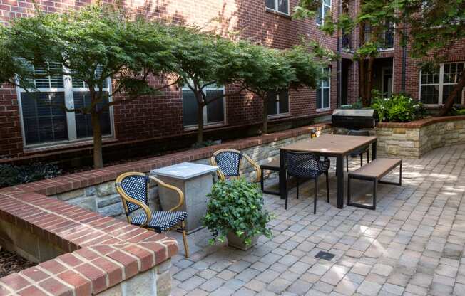 a brick patio with tables and chairs and a fountain