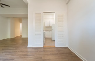 a bedroom with a medium hardwood floor and white walls