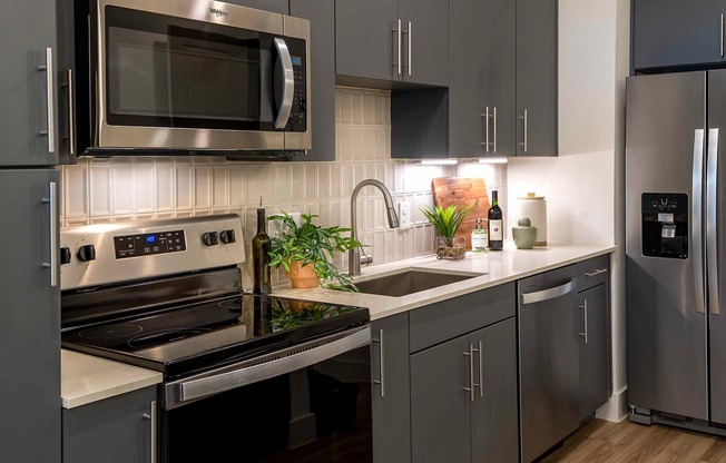 Add a touch of sophistication to your kitchen with the stylish tile backsplash at Modera Garden Oaks.