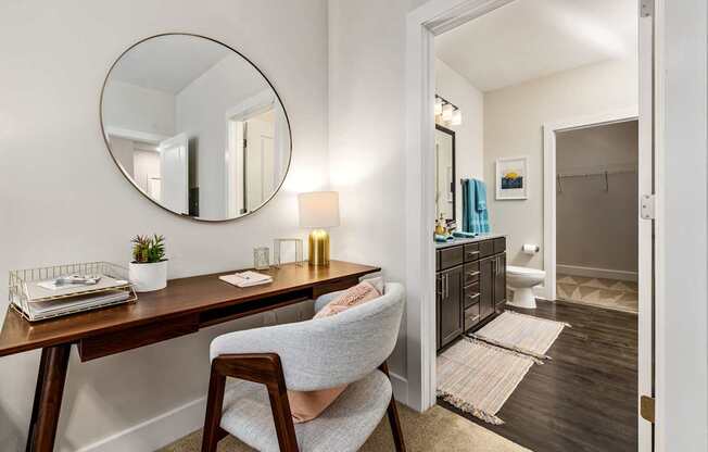 A room with a desk and chair in it.