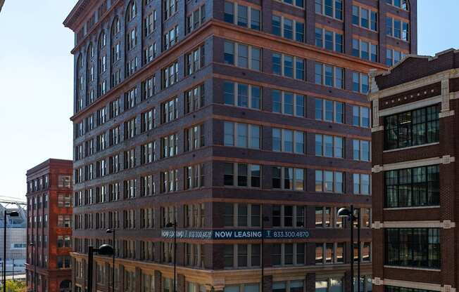 a tall brick building with a street in front of it