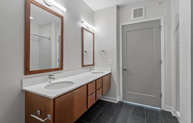 A bathroom with a sink, mirror, and wooden cabinets.